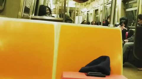 Green shirtless guy glasses hangs from subway railing