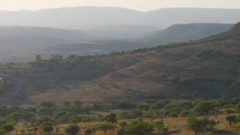 Flying over mountain ranges in the warm savanna