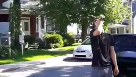 Redbull guy kickflips on street and falls into blue car trunk