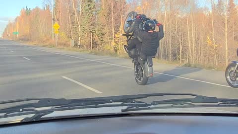 Motorcyclist Pops a Long Wheelie