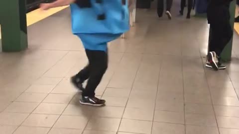 Man spinning in blue outfit dreidel