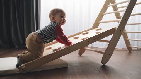 A Child Crawling on His Wooden Toy