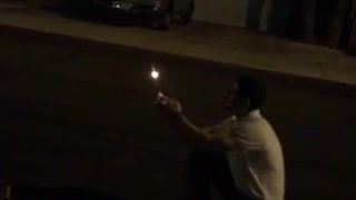 Guy lights firework rocket in his hand and it doesnt launch camera stops before it explodes