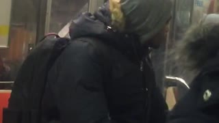 Hoodie guy smokes cigarette on subway car