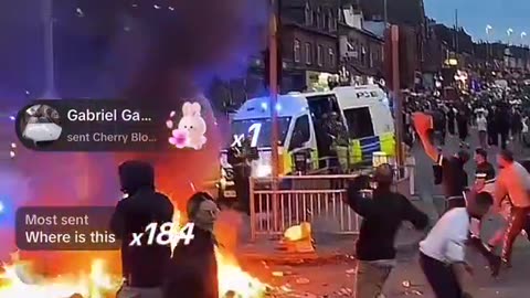 British riot police fleeing into police vans while being pelted with rock