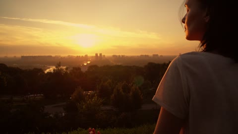 Girl meditating in yoga pose at sunset