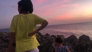 Okinawa seawall sunset with family