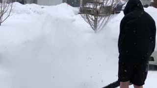 Son Clears Snow in Shorts