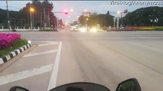 Motorcyclist Has Close Call with Red Light Running Semi