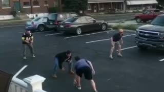 Guy in jersey falls down while trying to play flag football in parking lot