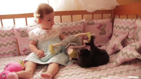 Cute_baby_having_fun_playing_with_crazy_kitten