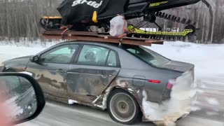 Cheap Car Carries Expensive Snowmobile