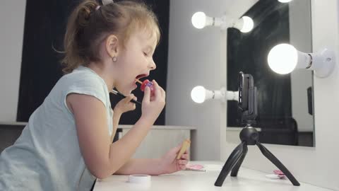 Cute little girl play with makeup