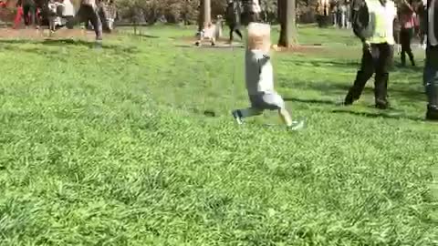 Blonde baby falls while running down hill