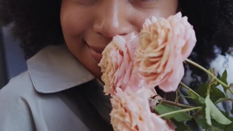A girl smells flowers