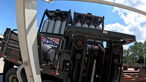 Forklift Operator Loading Flammable and Nonflammable Gas on Truck