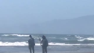 Man taking pictures on beach