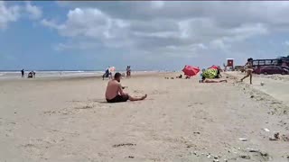 Man Falls Trying to Pass Soccer Ball at the Beach