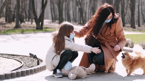 The mother and daughter have a problem with the little puppy in the park