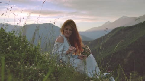 A beautiful girl gathering flowers