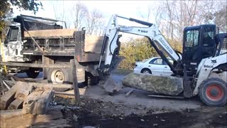 E50 and A300 Loading Big Rock Into Truck