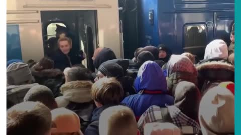 Ukrainians pass child to train passengers for safety