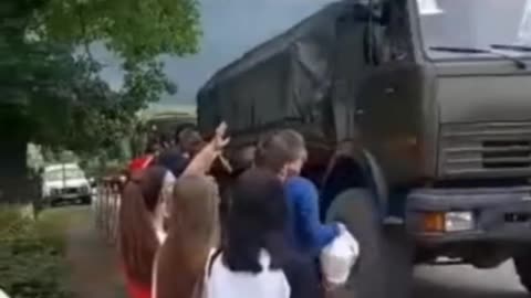 Russian citizens give gifts to convoy drivers