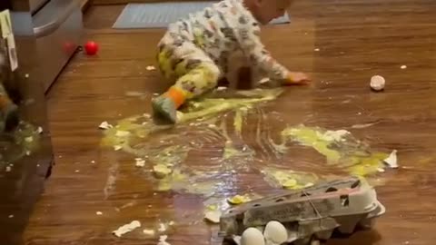 Funny video of little kids having fun with mom playing on floor braking eggs