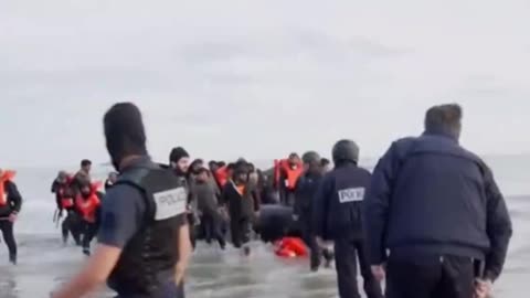 French police puncture a dinghy carrying "asylum seekers" bound for UK.