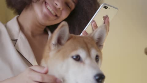 A Woman Taking Selfie Photo With Her Dog.