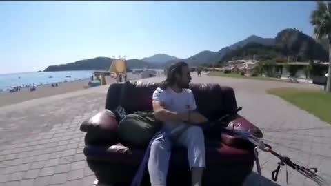 Man Attempts to Paraglide With a Couch