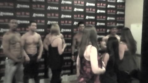 Girls taking pictures with the Chippendales at the Riviera in Las Vegas.