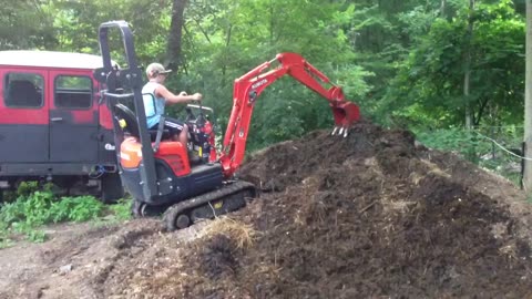 Jims Excavator #23 - Daniel aerating the manure pile.