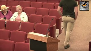 Man with gun at school board meeting warns about 'violence', later charged