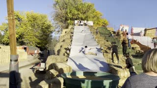 Kiddo Smooshed at the Bottom of the Slide