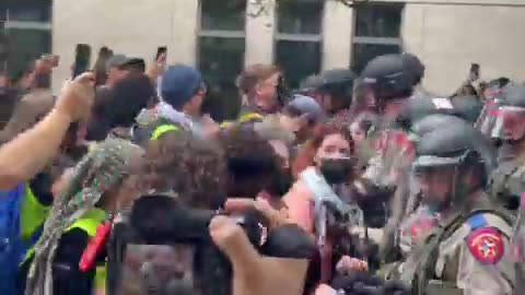 Protesters and DPS riot officers confront each other at the University of Texas in Austin