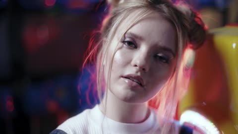 Close Up Shot of a Female in The Arcade with Neon Lights