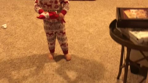 Little Girl Holds the Elf-On-The-Shelf