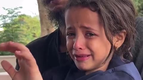 A young Palestinian girl bids a heartfelt farewell to her mother, father, and little brother.