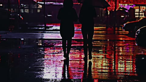boy and girl catch a taxi at night in the rain
