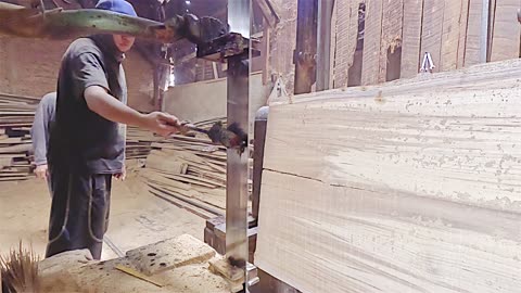 The process of chopping quality dry teak wood into thick boards for making doors