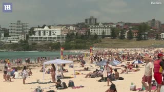 Australians hit the beaches in bikinis and Santa hats to celebrate Christmas
