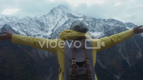 Hiker in Mountains Stretching Arms