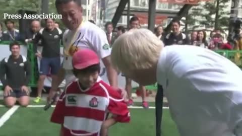 Boris Johnson knocks over boy in rugby match in Japan