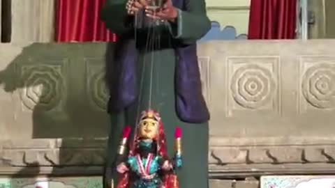 Man Entertains Crowd With Puppet Dance