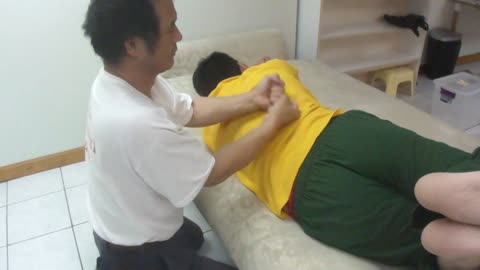 Luodong Massages His Son At Home