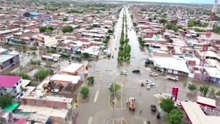 Peruvians move belongings through flooded streets