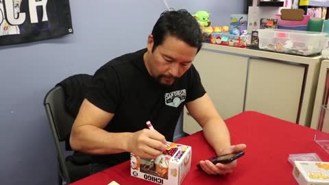 Johnny Yong Bosch signing Ichigo Funko Pops at Reborn Anime