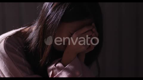 Depressed woman crying alone in the dark