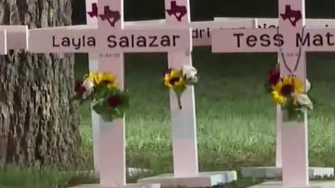 21 crosses stand in front of Robb Elementary School in Uvalde, Texas